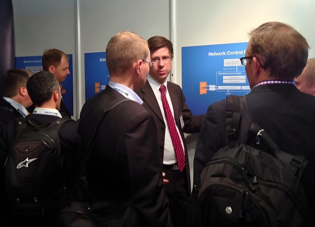 Visitors interacting at Tail-f’s booth during the trade show – with live product demos and technical presentations